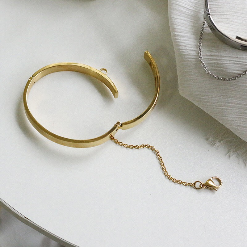 Thin Gold Color Plated Cuff Bracelet with Chain Closure is a thin sized Bracelet that has our signature chained hook closure